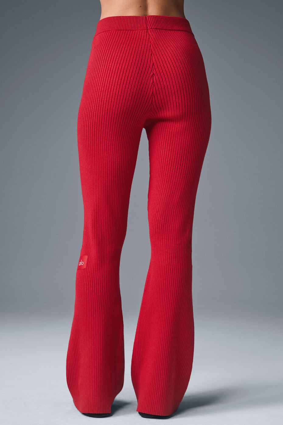Side view showcasing the flared leg of the high waist pants.