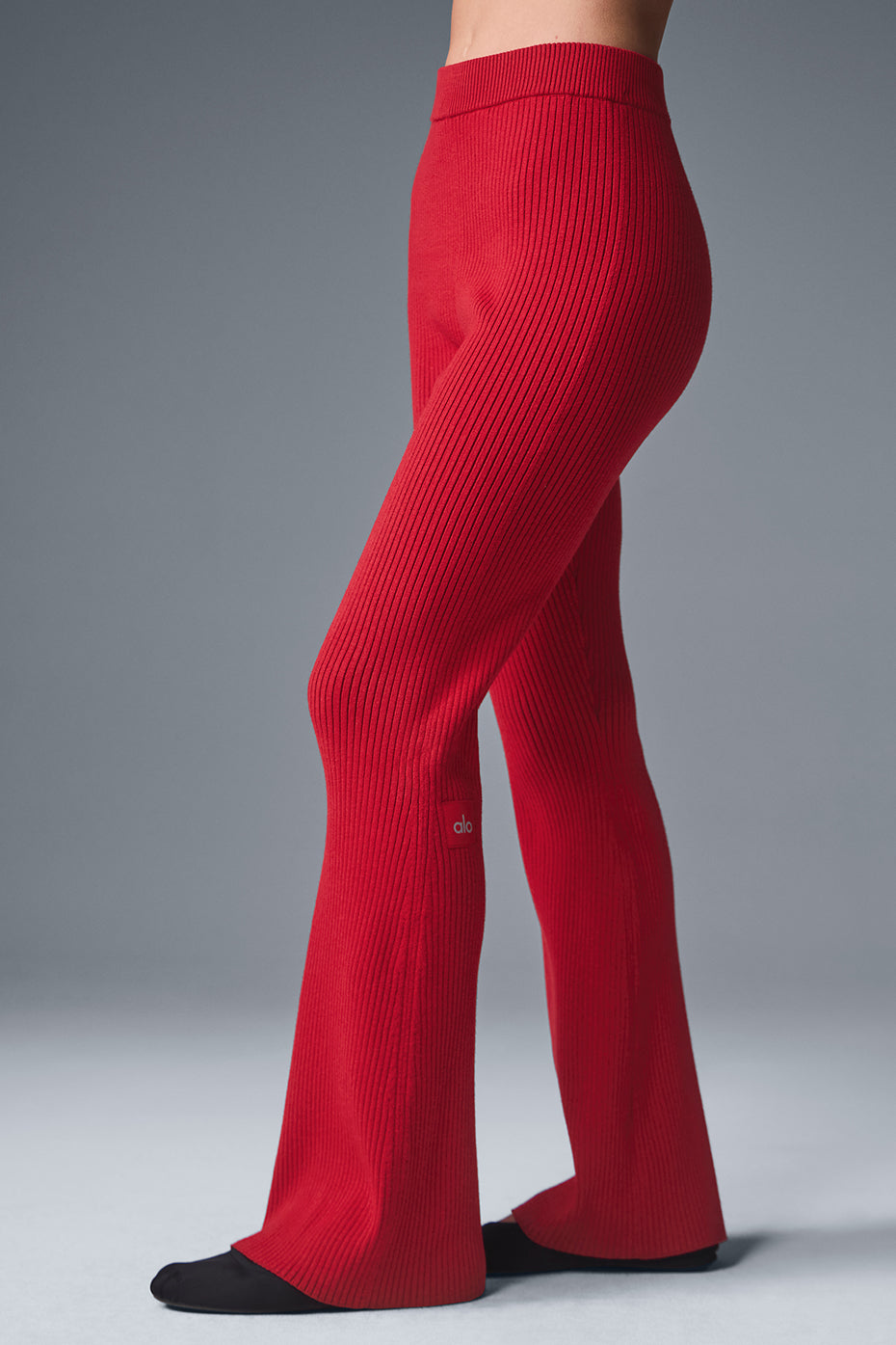 Back view highlighting the fit of ribbed knit flare pants.