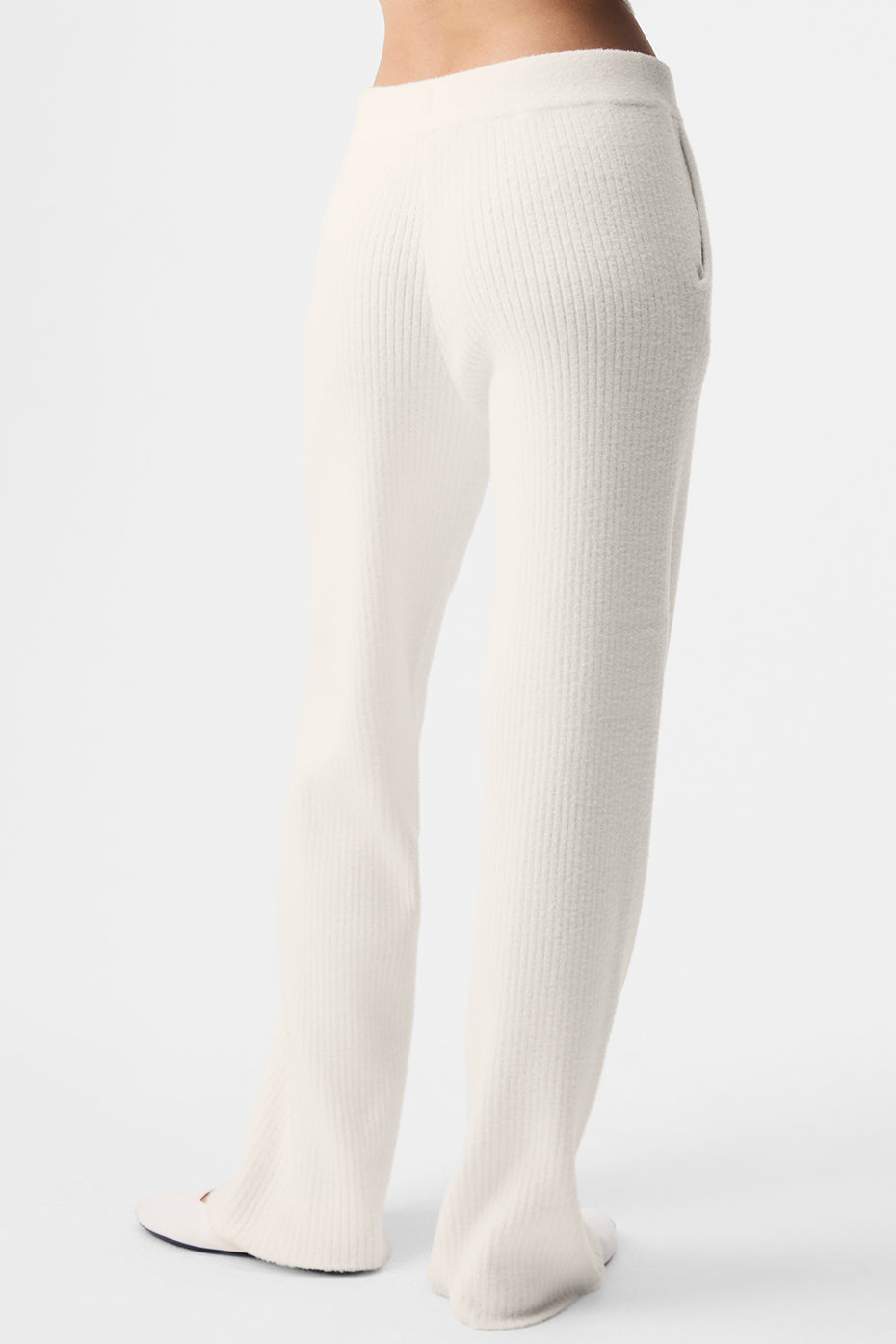 Mens lounge pants variant in charcoal gray, folded on a wooden bench