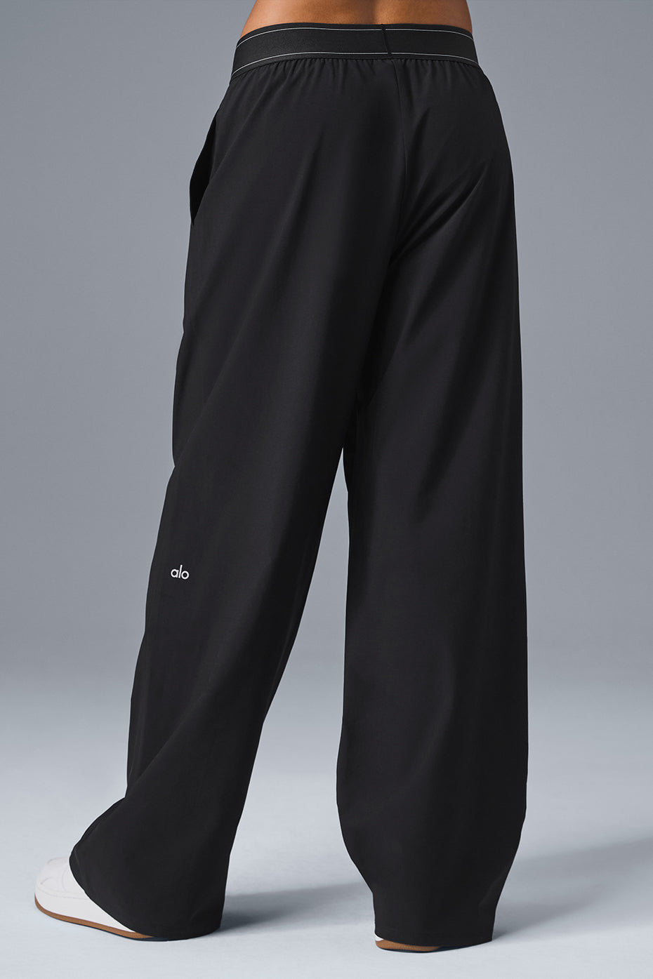 Chic high-waisted black trousers on a mannequin in a boutique.