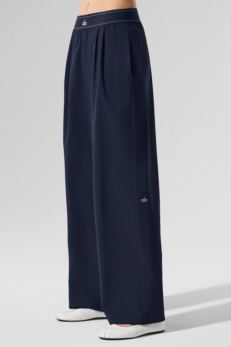 Close-up of navy trousers front pleats, perfect for womens casual wear.