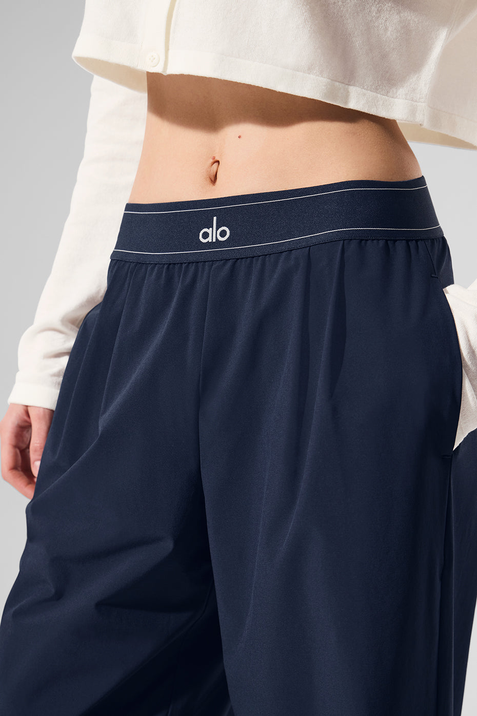 Model wearing navy trousers with a stylish top for a trendy work outfit.