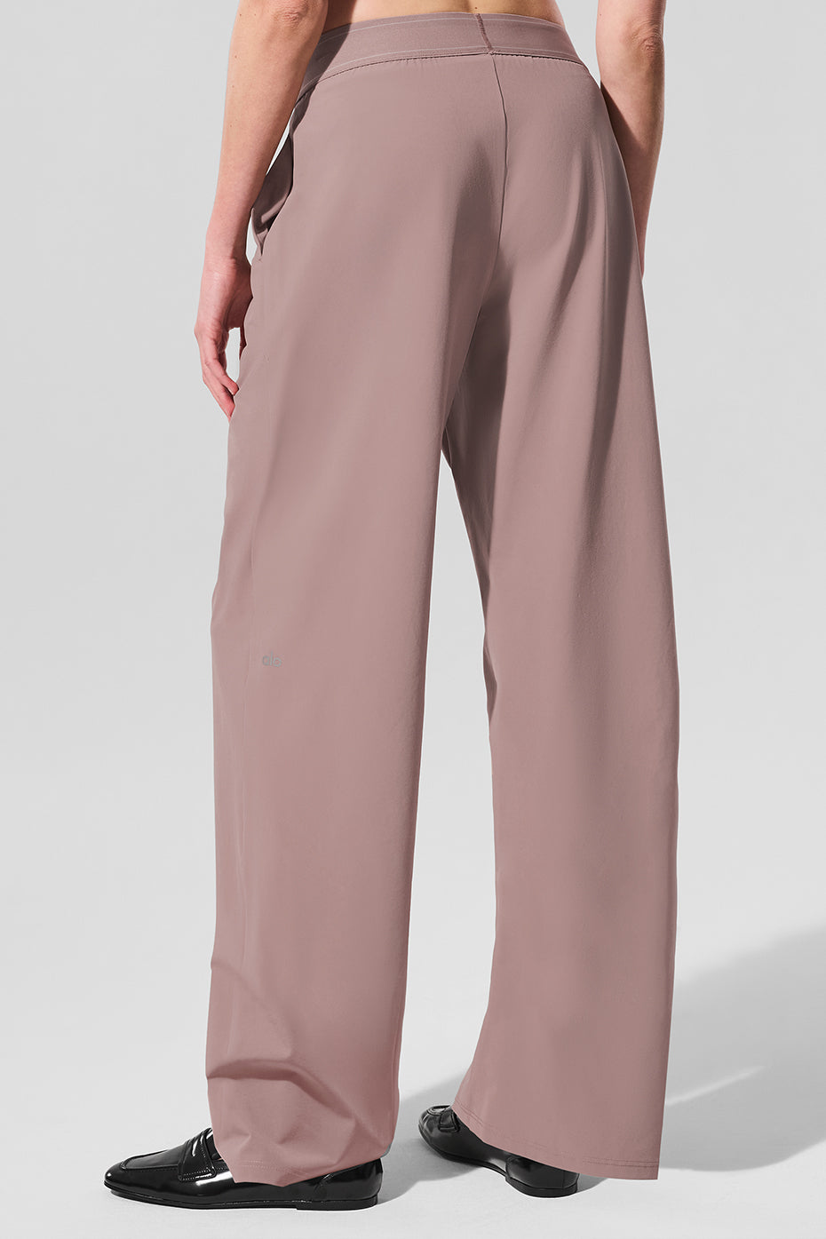 Front view of chic taupe trousers highlighting the elastic waistband.