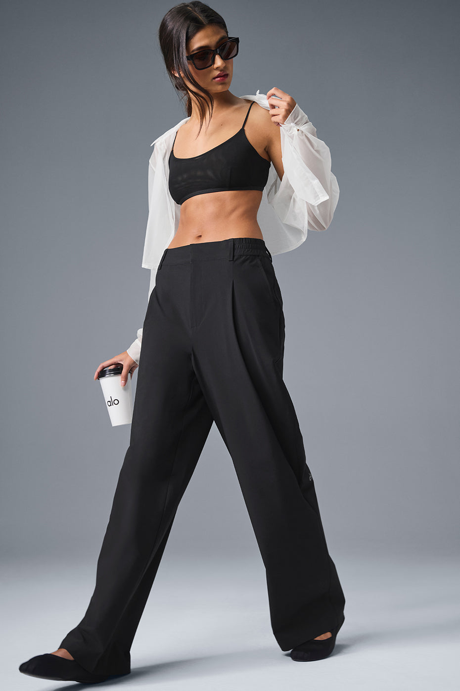 Model wearing high-waist trousers with a tucked-in sweater for workwear styling