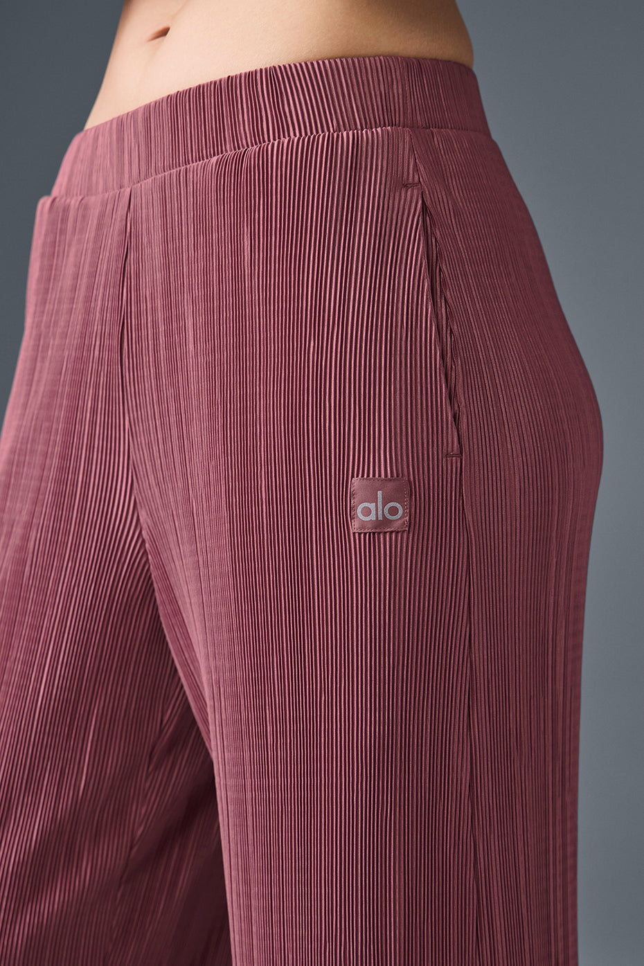 Close-up detail of the micro plisse texture on burgundy fabric