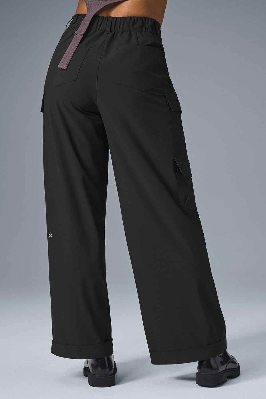 Side view showcasing the rolled cuff of black cargo pants.