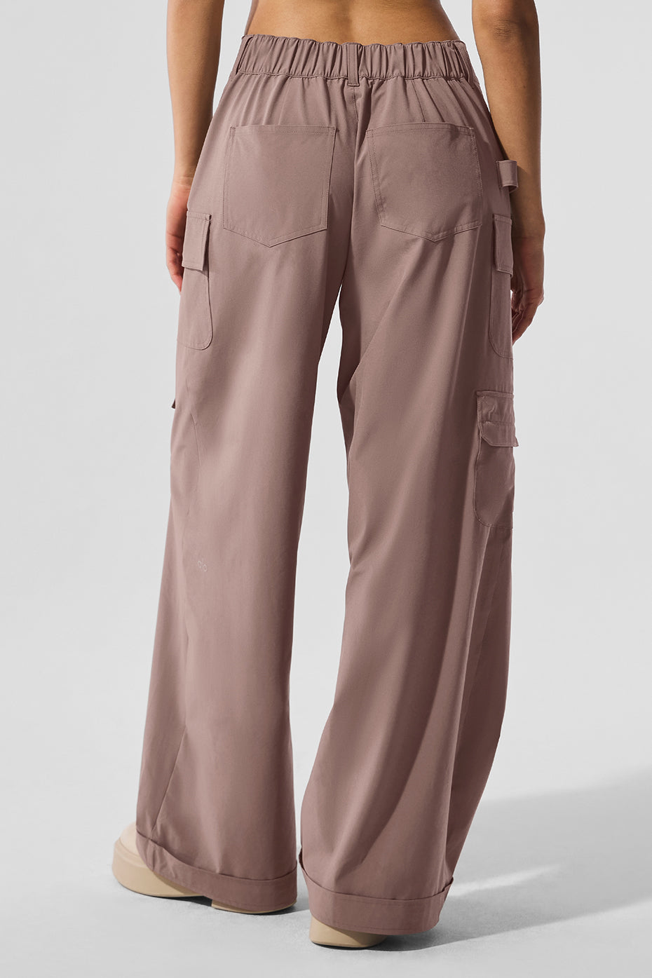 Mushroom cargo pants styled with casual footwear in an outdoor setting.