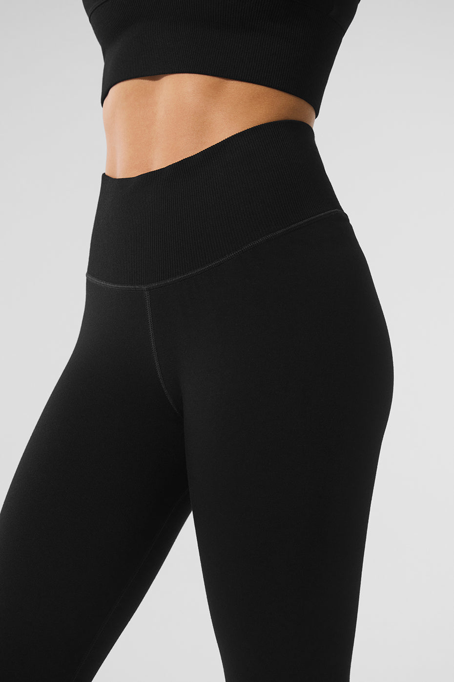 Flat lay of girls fleece lined leggings paired with knitwear and accessories for layering