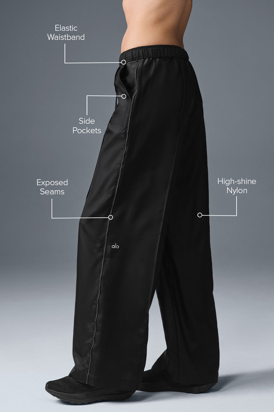 Close-up of the exposed seam detail on black linen pants