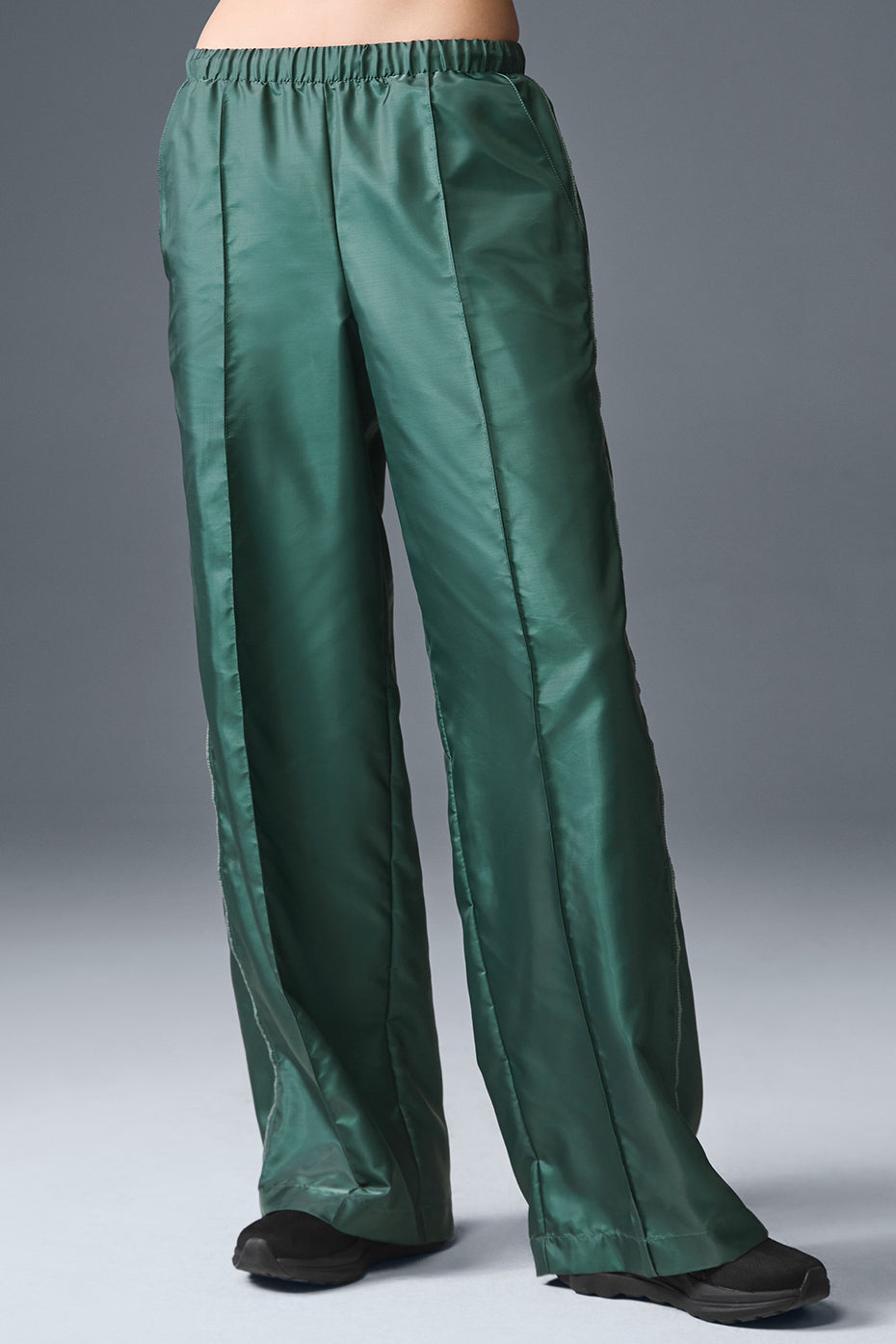 Front view of Afterglow Wide Leg Track Pants in Winter Ivy, showcasing relaxed fit.