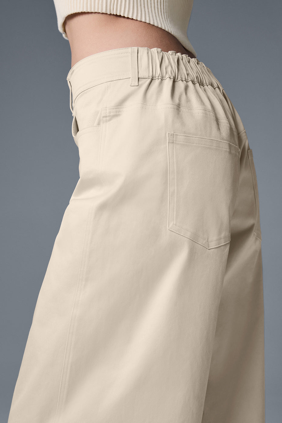 Low-rise black trousers styled with a white blazer for office-to-bar transitions