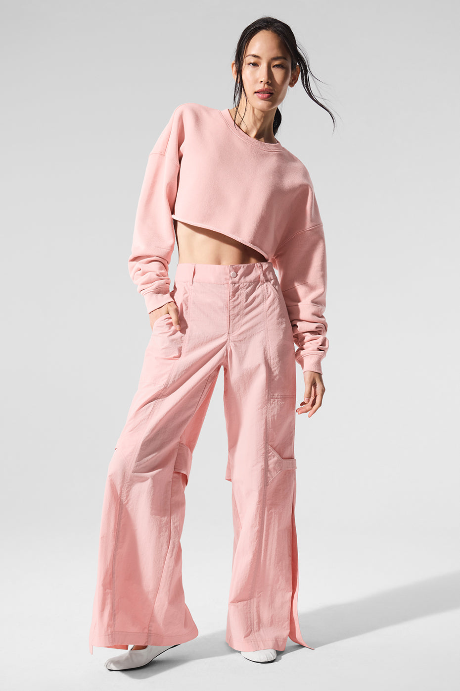 Front view of high-waist Voyager trousers in Pink Quartz styled with a crop top