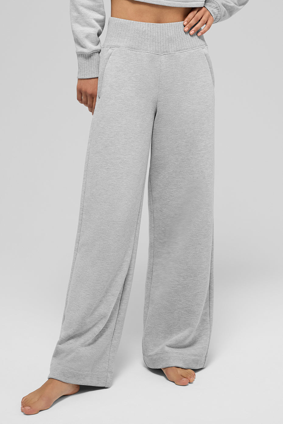 Athletic sweatpants draped over yoga mat with water bottle