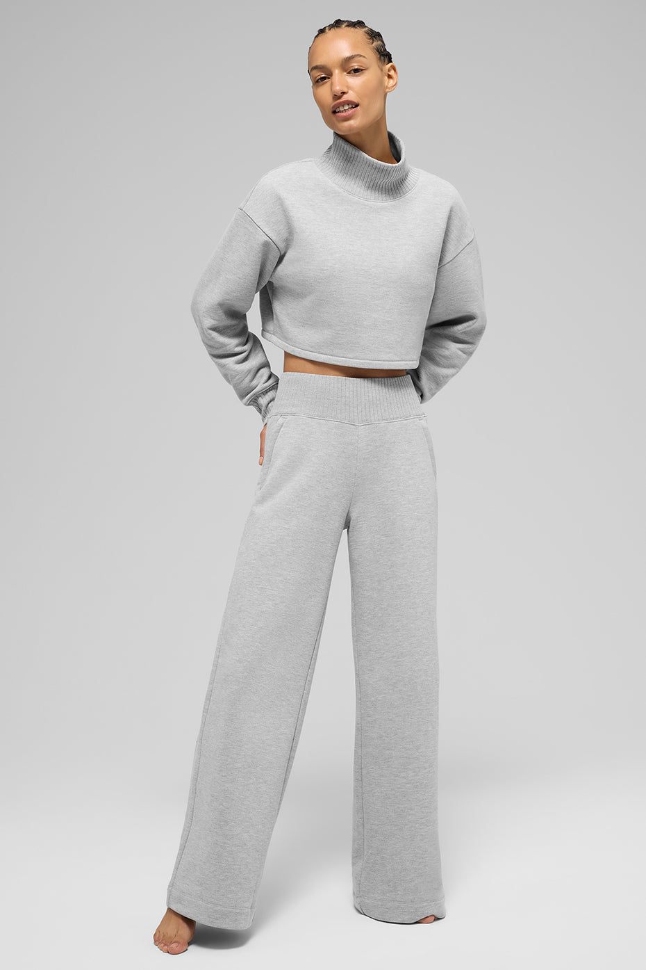 Athletic sweatpants draped over yoga mat with water bottle