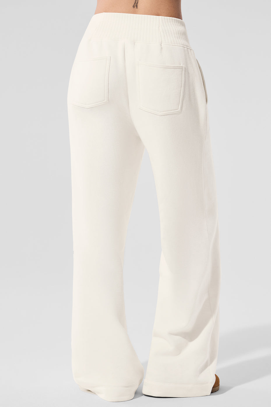 Front view of womens wide leg sweatpants in ivory, styled with coverup