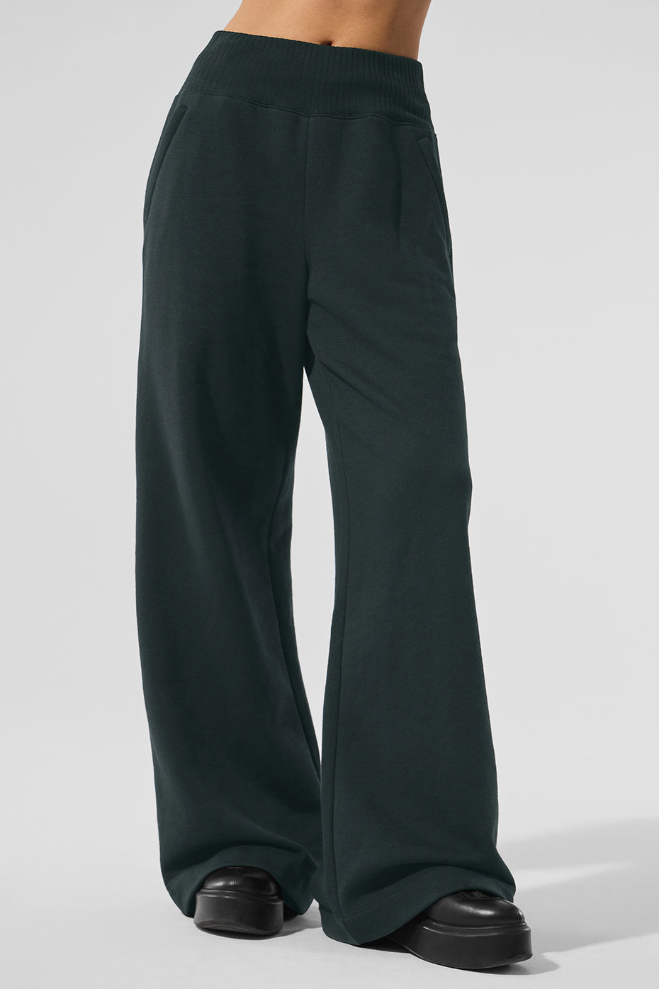 Front view of women's wide leg sweatpants in charcoal green with zippered pockets