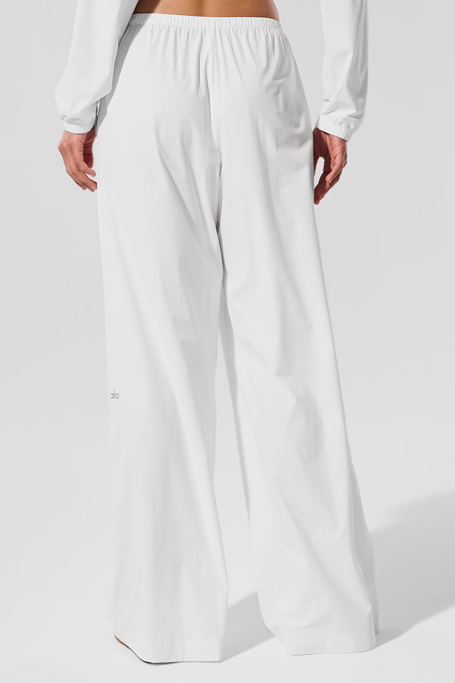 Wide leg yoga pants in white, styled for a casual day out.