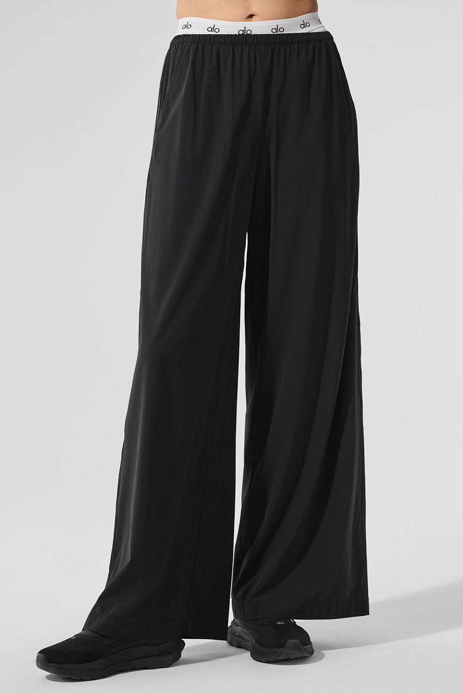 Woman wearing black wide leg pants with a casual tee, ideal for LA weekends