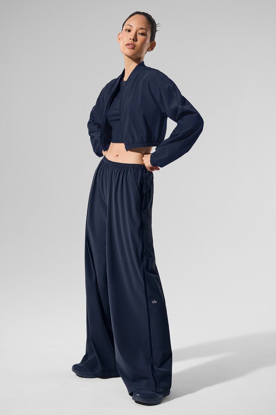 Back view of white wide leg pants styled with a neutral top for a minimalist look.