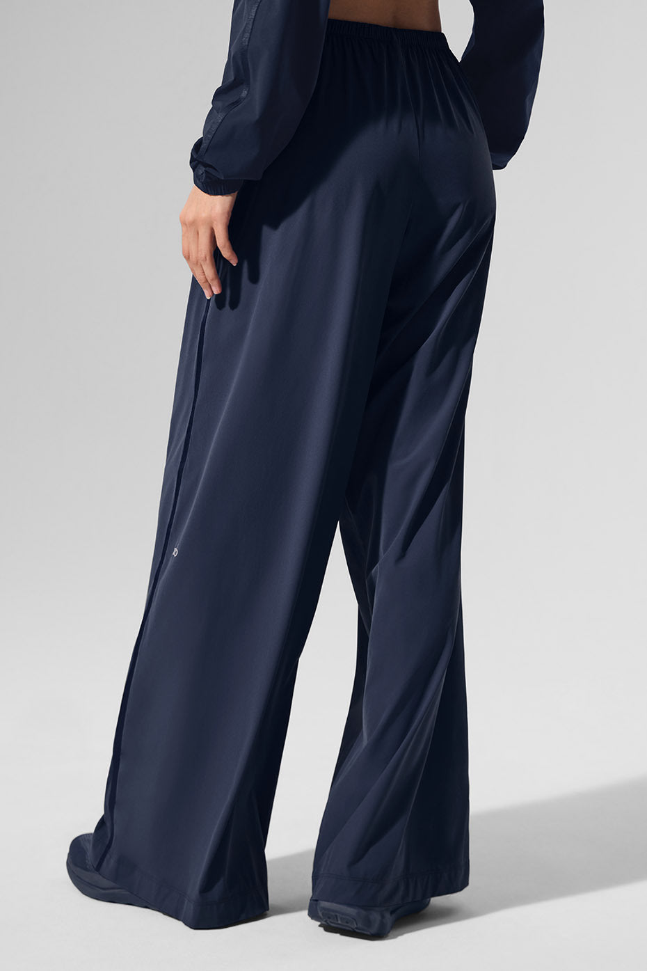 Back view of white wide leg pants styled with a neutral top for a minimalist look.