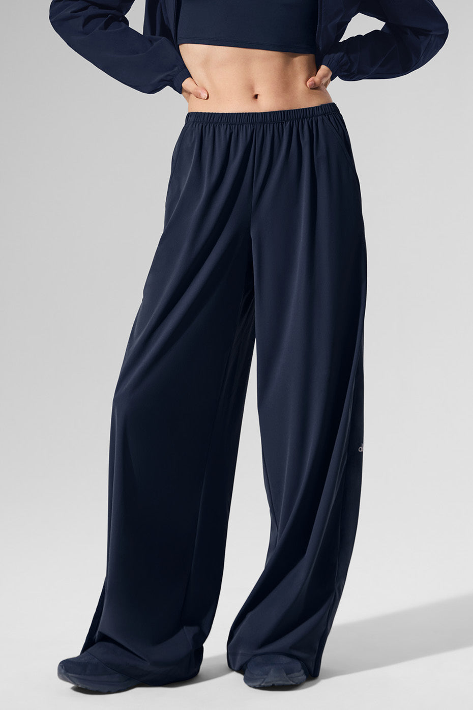 Close-up of navy wide leg pants showing stretchy fabric and waistband detail.