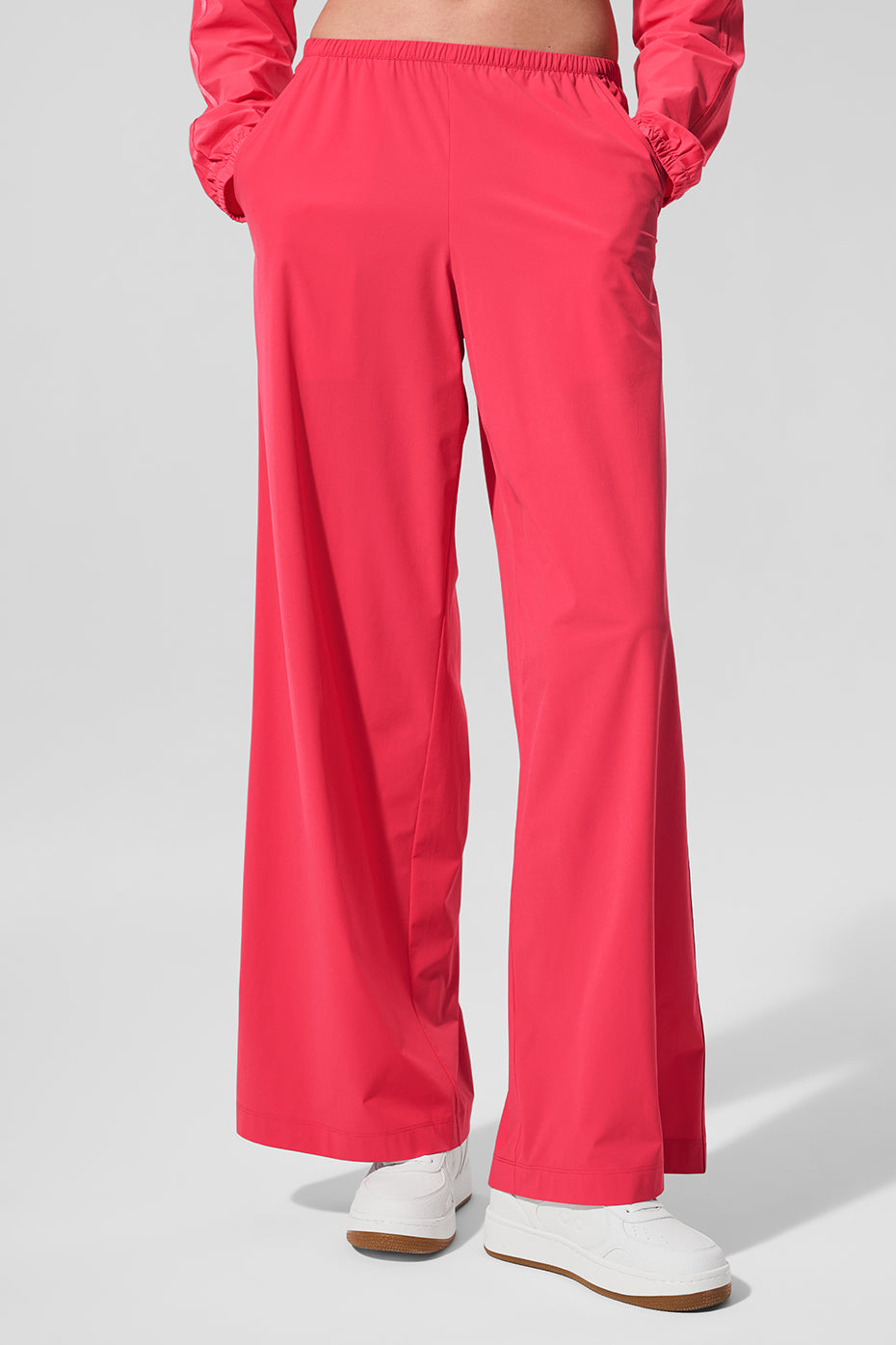 Side view of candy red wide leg pants worn casually.