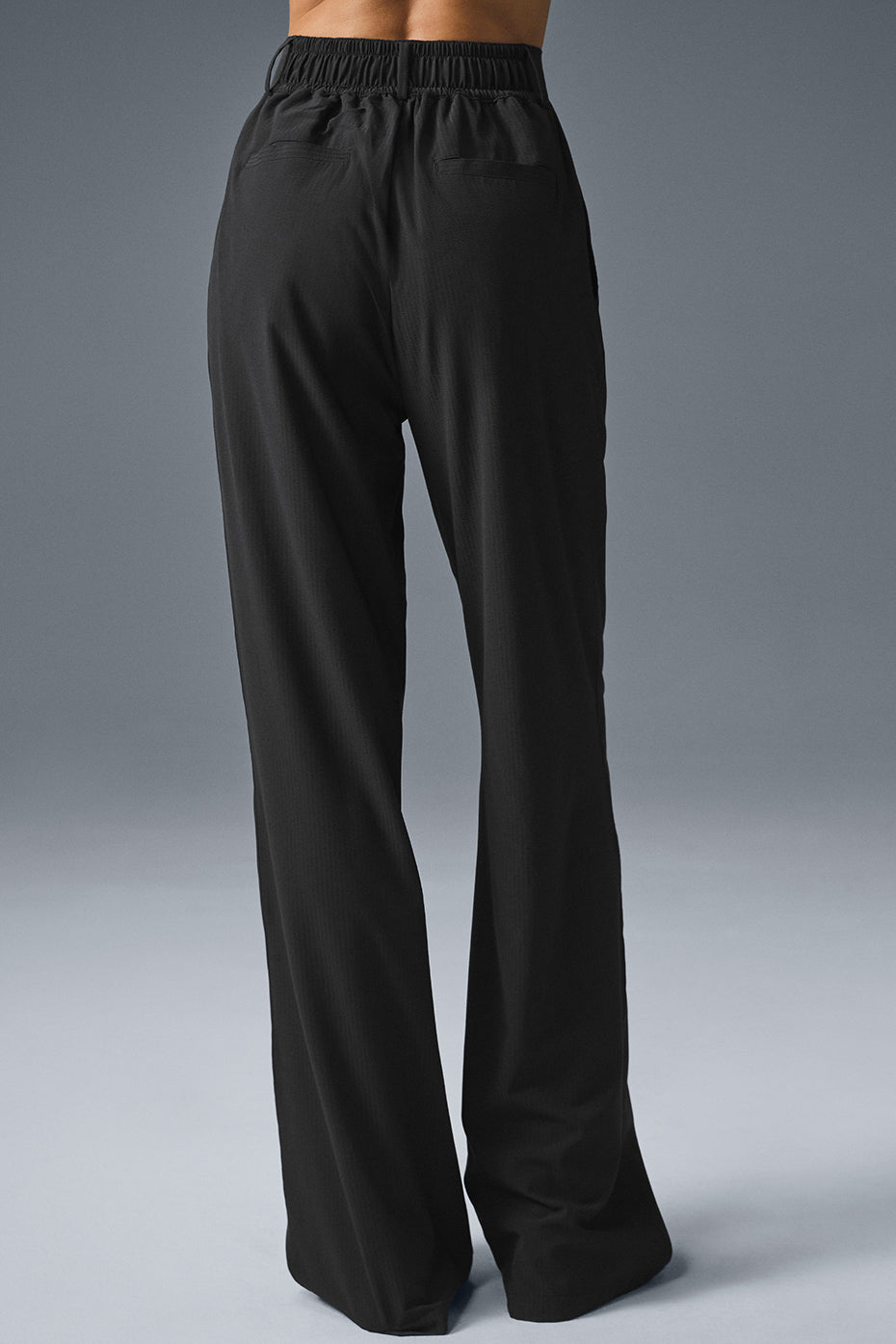 Styled pleated ladies trousers paired with button-down in urban setting.