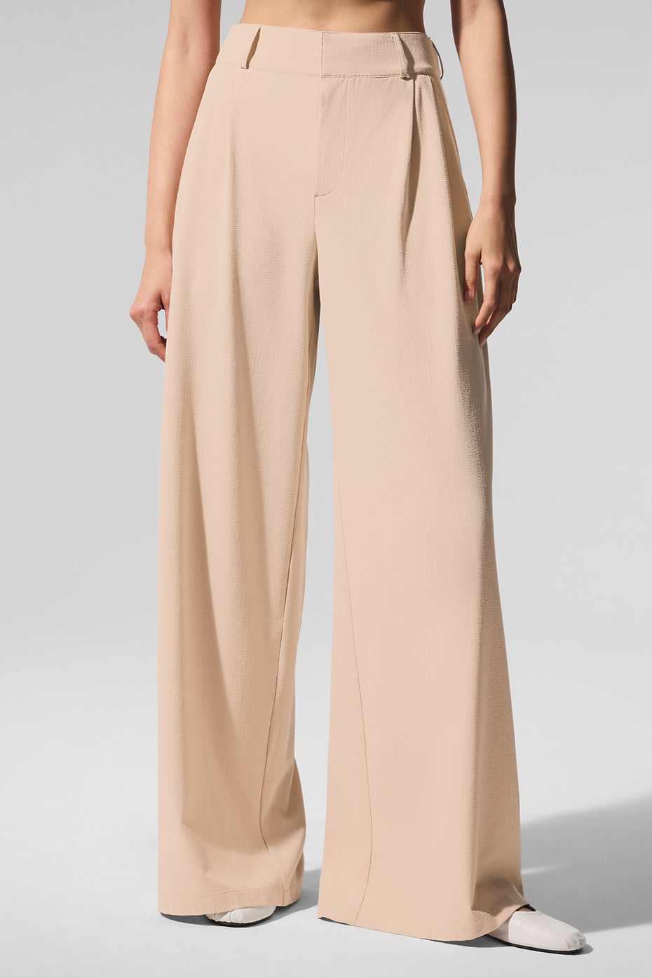 Full-length view of mens pleated trousers styled for everyday wear