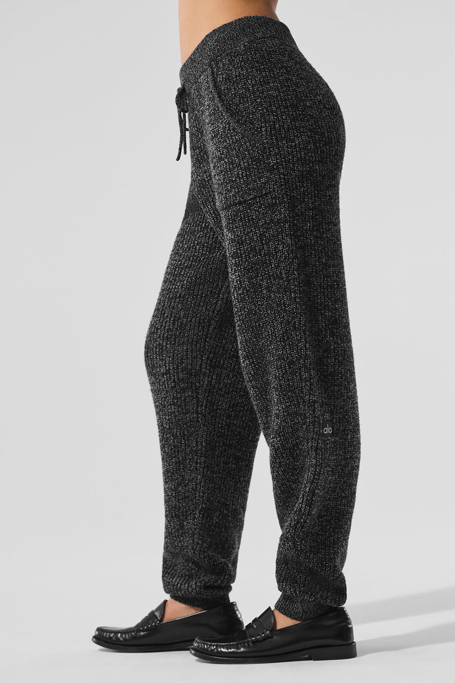 Front angle view of black jogger pants styled with a loose-fit hoodie