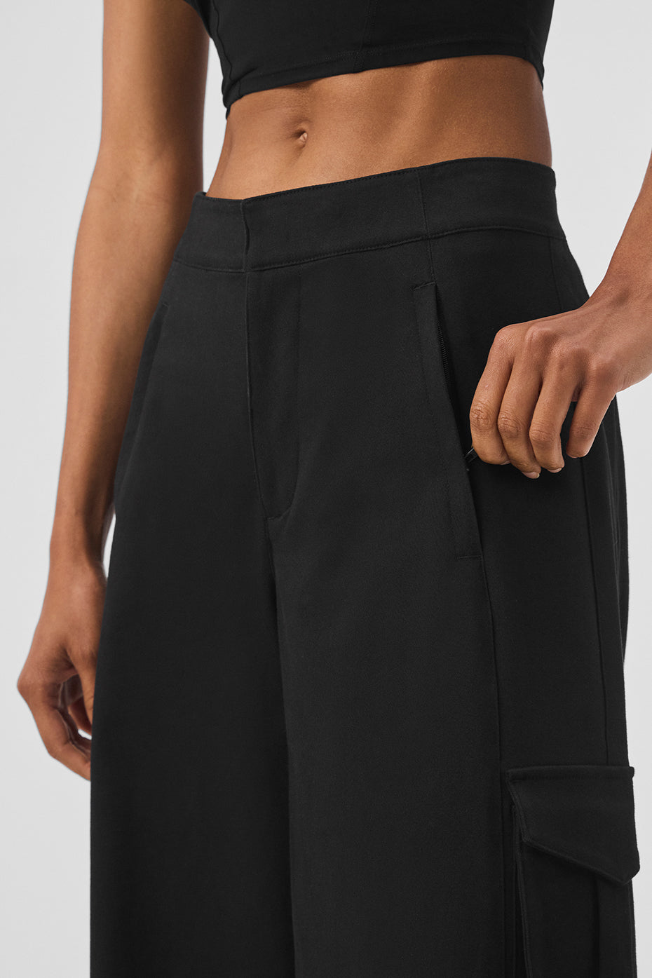 Front view of black cargo trousers with wide legs.