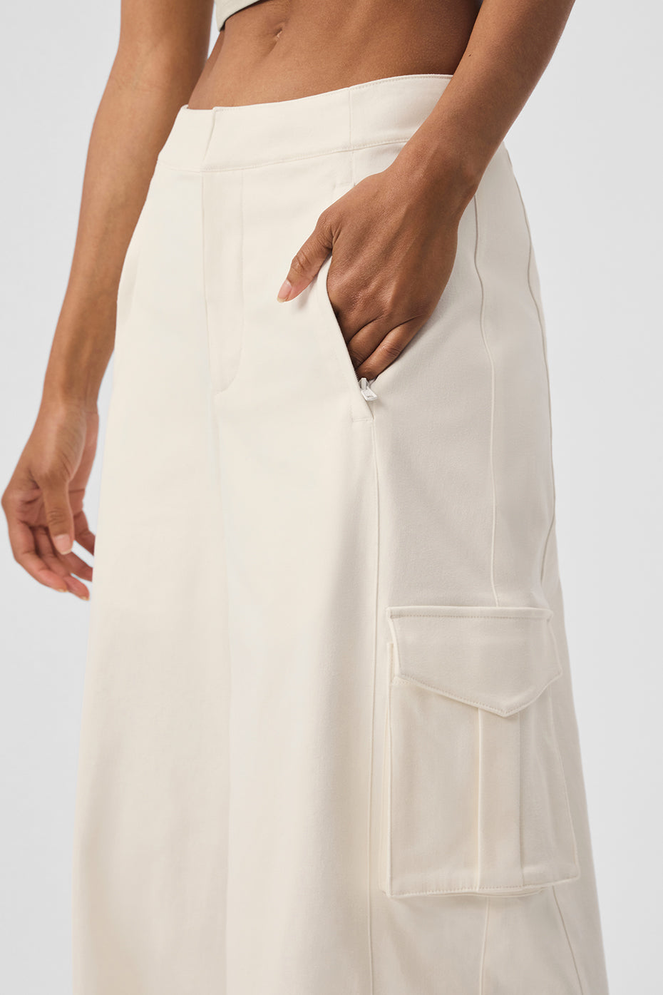 Front view of ivory wide leg trousers with cargo pockets on model