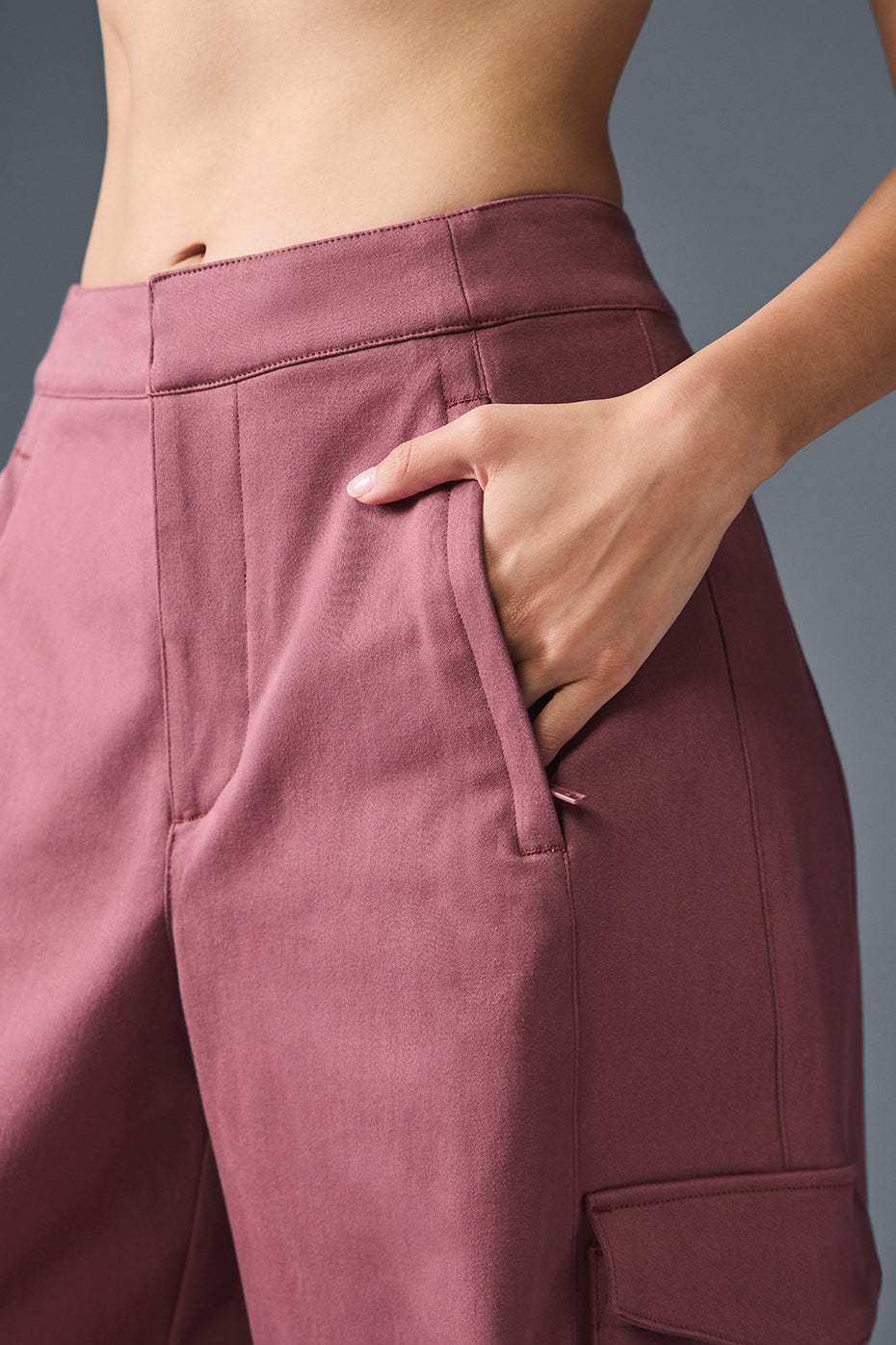 Outfit shot featuring burgundy pants with white sneakers