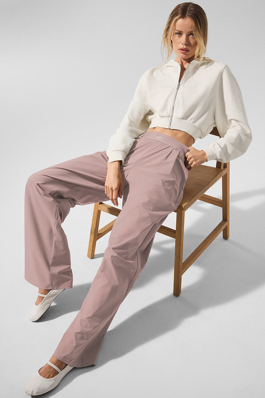 Side view of taupe suit up long trousers with front pleats and elastic waistband