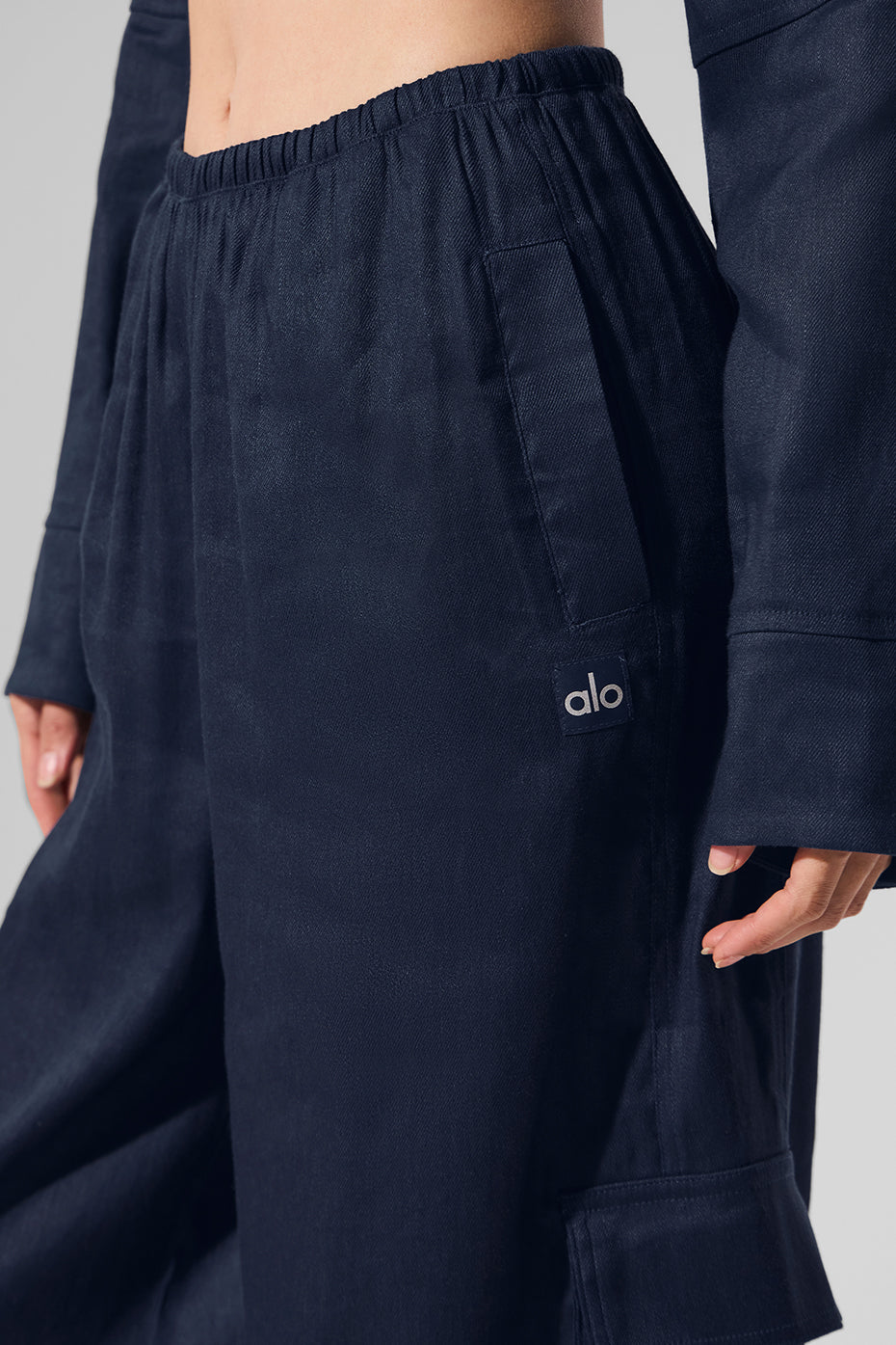 Close-up of the breathable fabric of navy linen cargo pants.