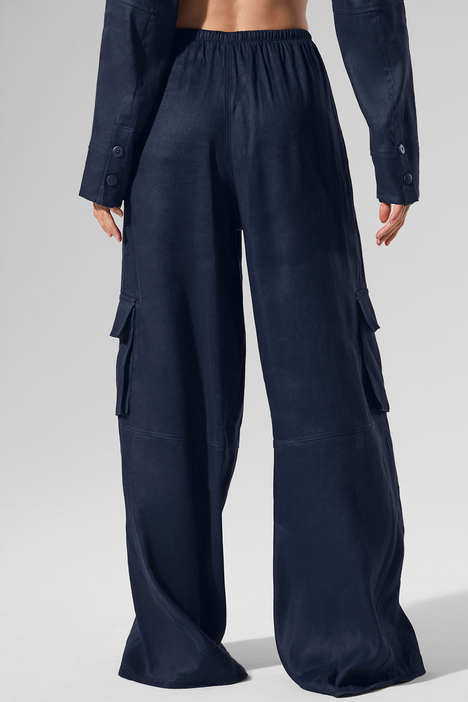 Navy linen cargo wide leg pants styled for a beach sunset.