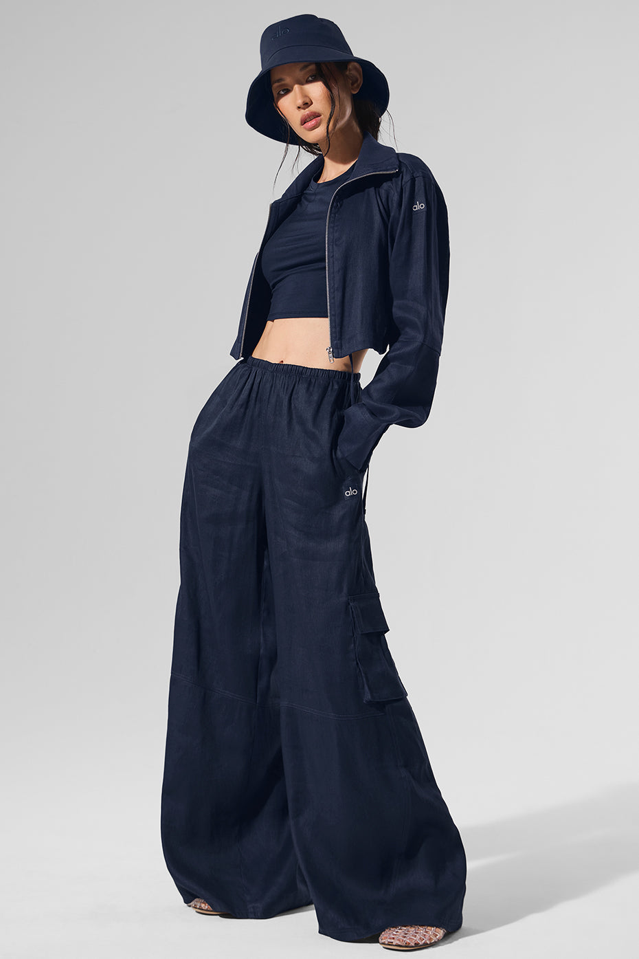 Model wearing navy wide leg cargo pants while dining outdoors.