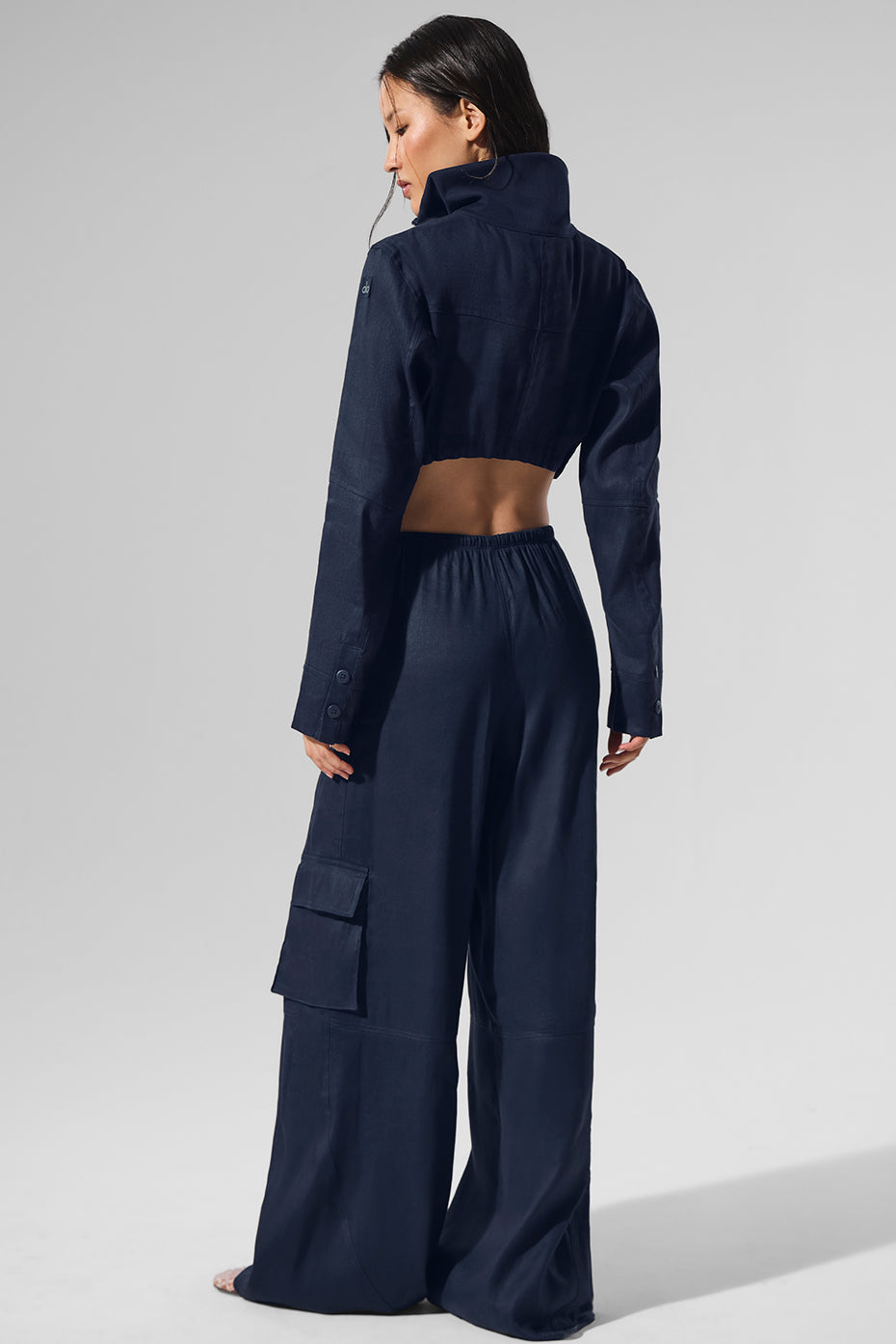 Model wearing navy wide leg cargo pants while dining outdoors.