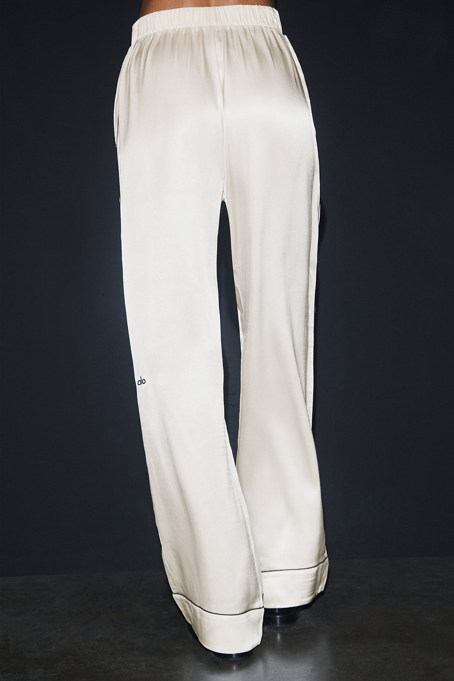 Model wearing the Courchevel Silk Pants paired with a silk blouse for an evening-ready look.