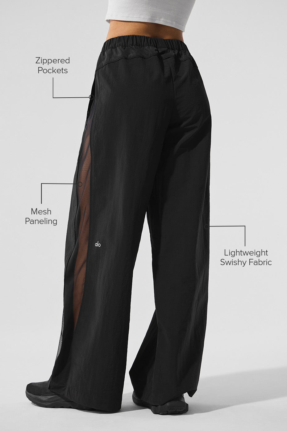 Side view showcasing the wide-leg design of the track pants.