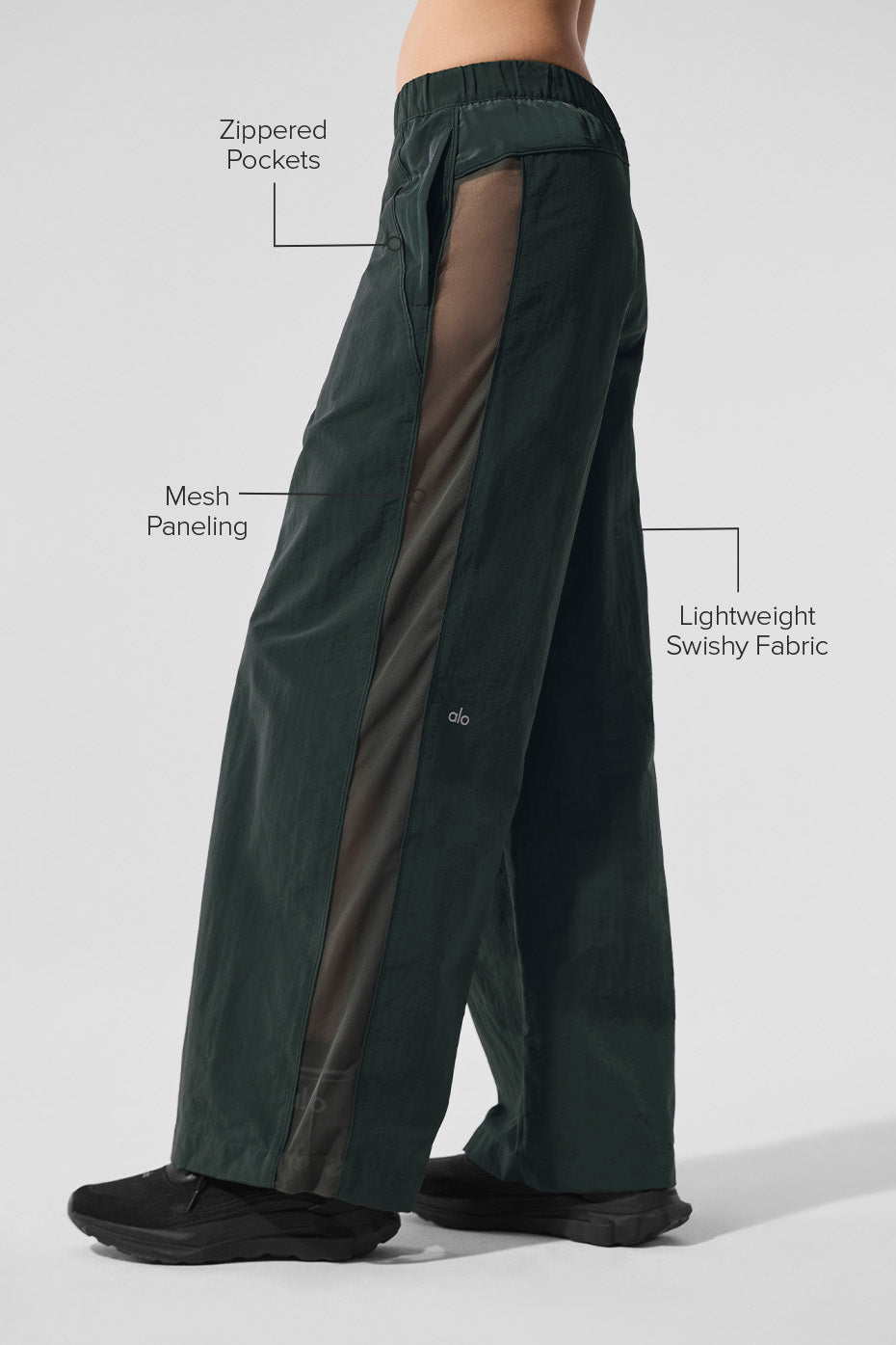 Side view showcasing the mesh paneling of the wide leg track pants.