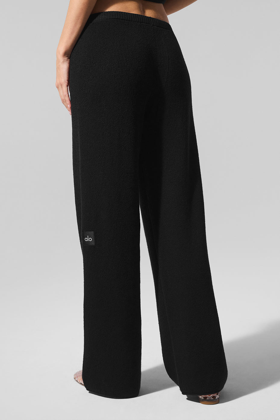 Front view of womens lightweight knit pants in black, styled for a casual outing.