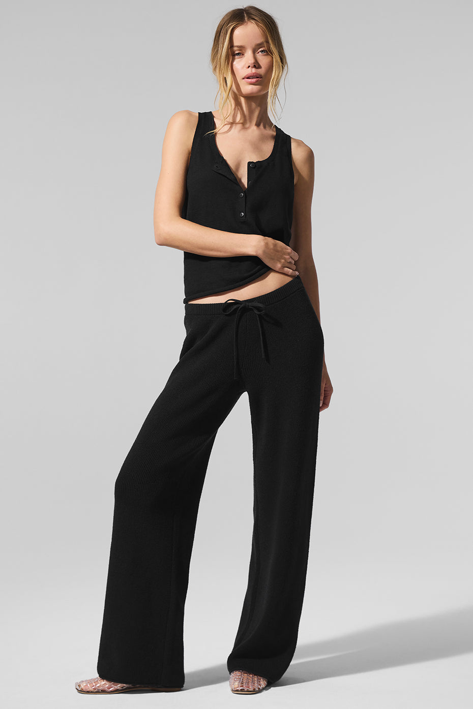 Side view of mid-rise knit pants, showcasing their breathable fabric.