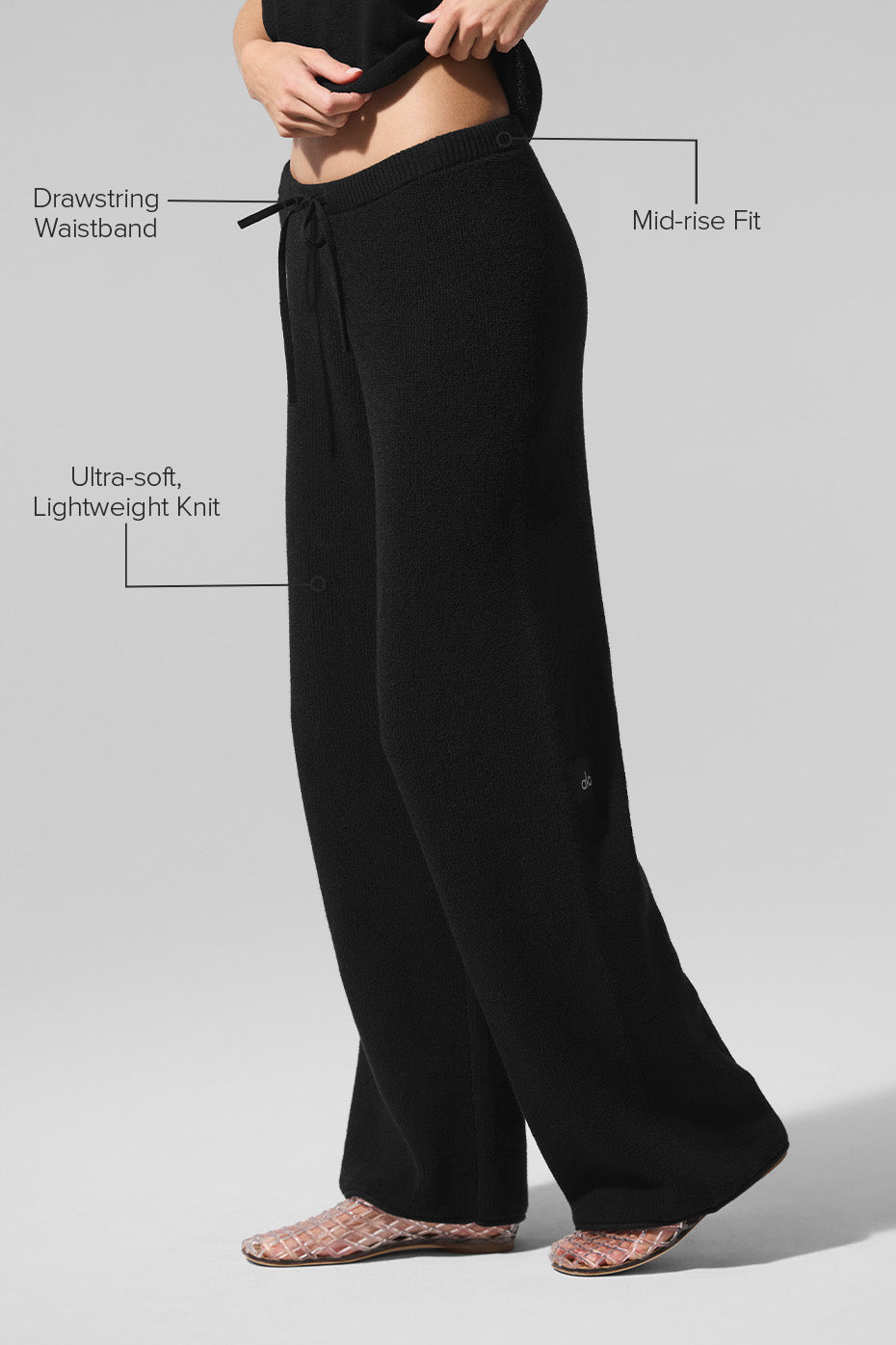 Side view of mid-rise knit pants, showcasing their breathable fabric.