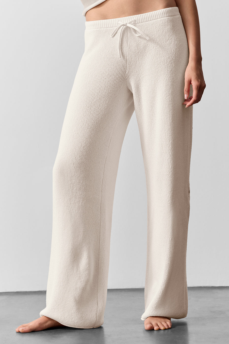 Close-up of ivory sweater pants highlighting soft knit fabric