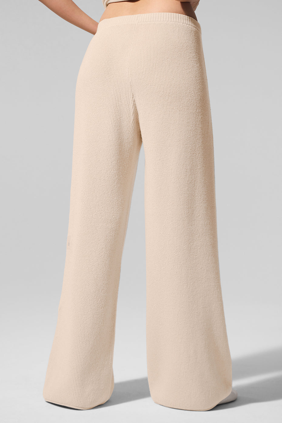 Lightweight knitwear pants on a model walking along a dune trail