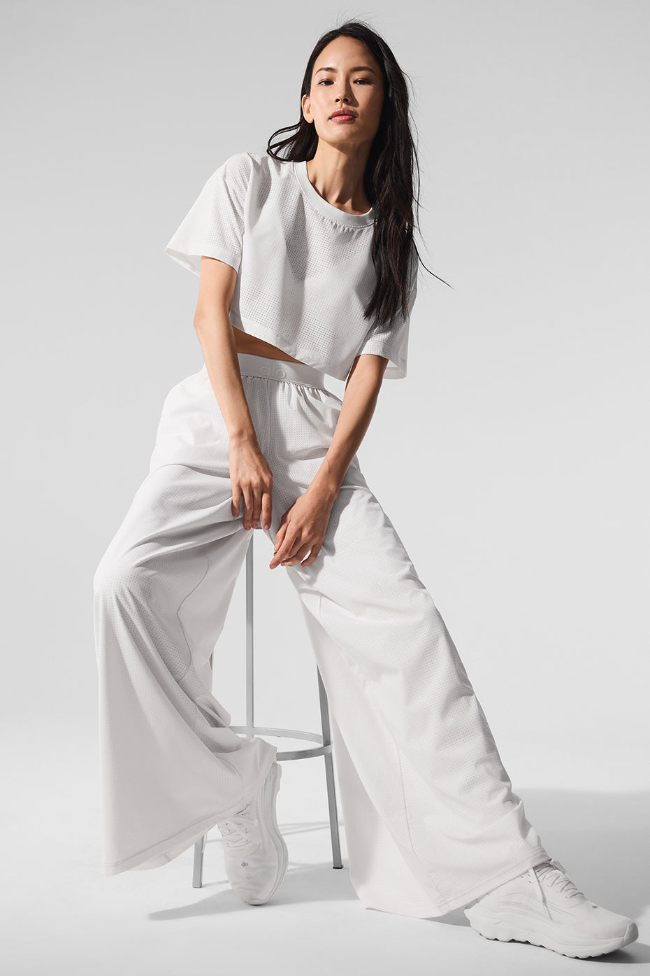 Breezy mesh trousers in white, ideal for summer travel.