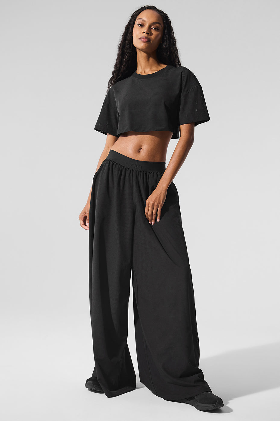 Flat lay of cargo trousers lightweight design with waistband detail on wooden surface