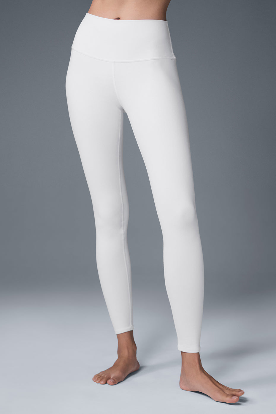 Close-up of white airbrush high-waisted leggings on a model.