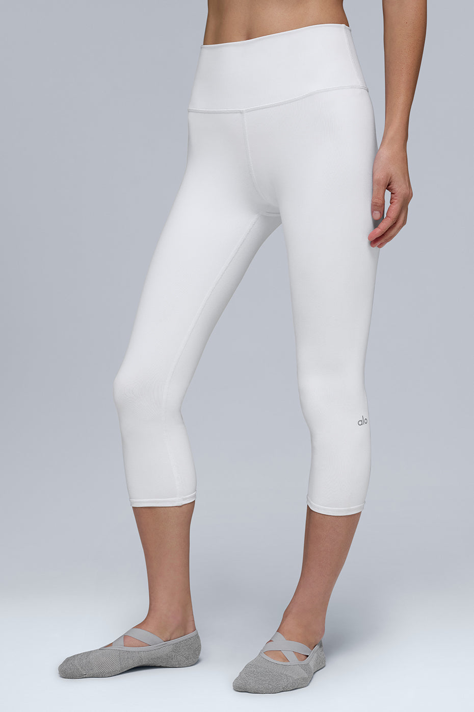 Front view of sculpting high-waist capri leggings in white, ideal for yoga.