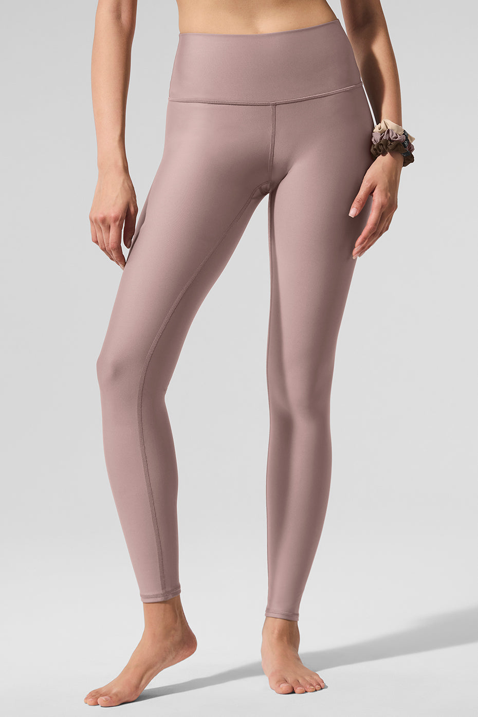 Woman wearing taupe high-waist leggings during yoga pose
